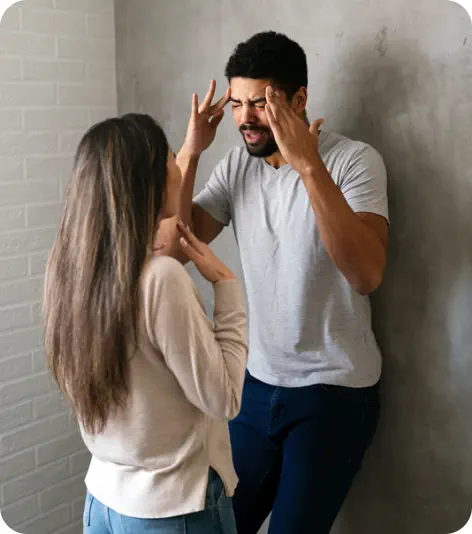 A young man and young woman are standing close to each other and arguing